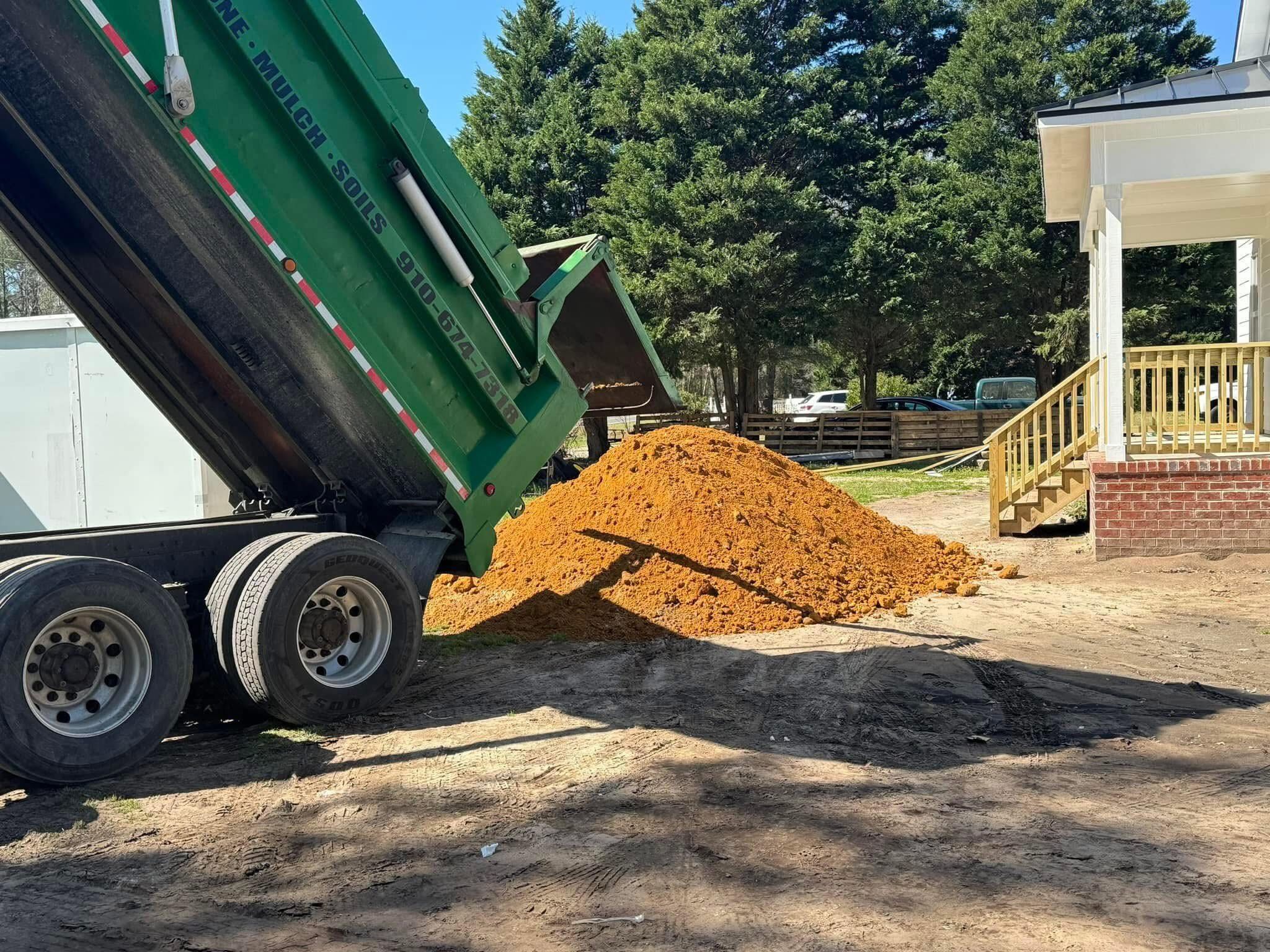 Bulk material being dumped at a customer job site