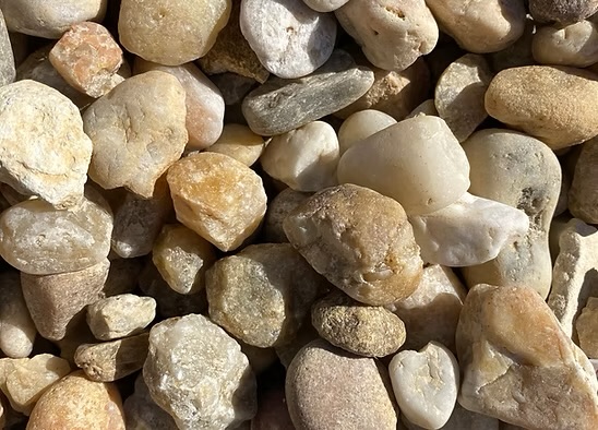 Palomino Creek Rock with rounded white, tan and gold stones